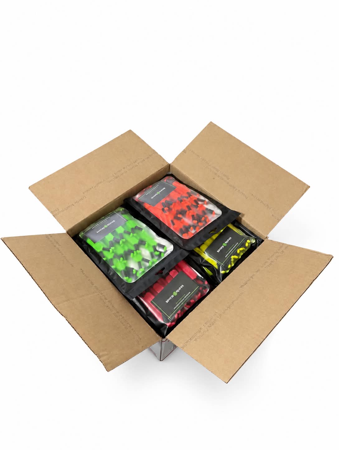 Open cardboard box containing our four color options of Shine Spine branch spreaders on a white background.